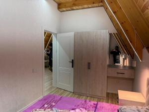 a room with a bed and a cabinet in a room at bag evi in Mardakan +1 photo