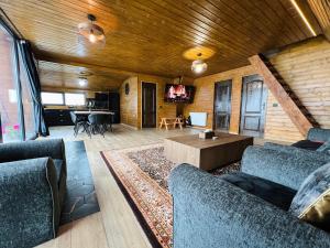 a living room with two couches and a table at A-Frame Retreat Vulcan in Vulcan