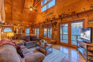 a living room with a couch and a tv in a cabin at Apple Cove in Vilas