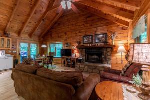 a living room with a couch and a fireplace at Trillium in Banner Elk