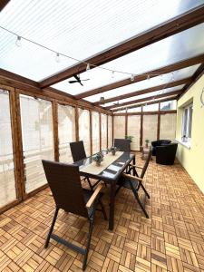 a screened in porch with a table and chairs at Ferienwohnung 'Moselzauber' in Ensch
