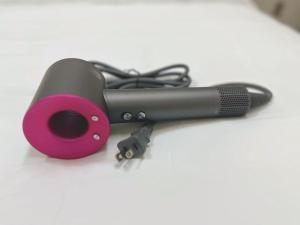 a hair dryer with a pink holder on a table at Shinjuku Downtown新宿 in Tokyo