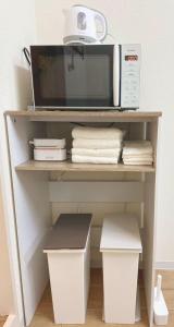a microwave oven sitting on top of a shelf at Shinjuku Downtown新宿 in Tokyo