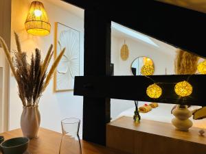 a room with a table with a mirror and a lamp at Le Champêtre - Centre du Rheu in Le Rheu