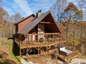 a cabin in the woods with a large deck at Ambleside in Vilas