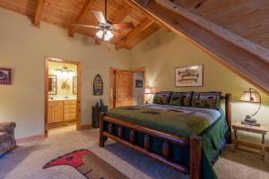 a bedroom with a bed and a wooden ceiling at Bear Creek in Sugar Grove