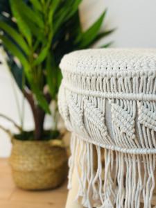 a white basket sitting next to a potted plant at Le Champêtre - Centre du Rheu in Le Rheu +1 photo