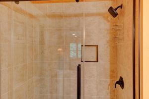 a shower with a glass door in a bathroom at Kaylee's Kabin in Vilas +40 photos