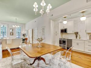 a kitchen and dining room with a wooden table and chairs at Gordon Inn Live Oak in Savannah