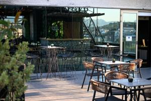 a group of tables and chairs on a patio at Hotel Arka in Skopje