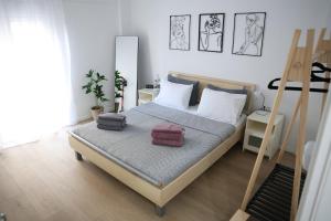 a bedroom with a bed with two towels on it at Modern Apartment G66 in the Center in Drama