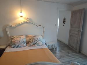 a bedroom with a large bed with a white headboard at Chez Christine et Fred in Villedaigne