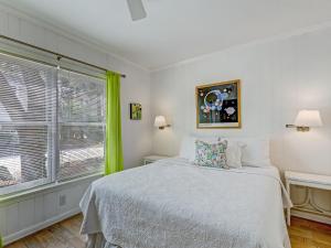 a bedroom with a bed and a large window at Coops Retreat Unit B in Tybee Island +24 photos