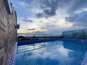 a large swimming pool on top of a building at MDM Hotel in Cordova