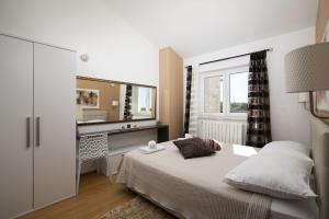 a bedroom with a bed with a vanity and a mirror at Villa Mason with Heated Pool and mini Wellness in Rovinjsko Selo +51 photos