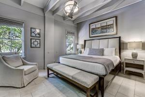 a bedroom with a large bed and a chair at Parker's Collection Unit 5 in Savannah +31 photos