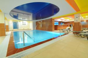 a large swimming pool in a hotel room at Penzion Forman in Rožnov pod Radhoštěm