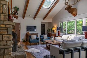a living room with a couch and a fireplace at Elk Watch at Hound Ears in Valle Crucis