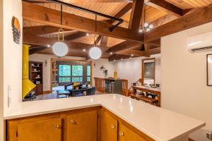 a kitchen and living room with wooden ceilings at Blue Ridge Retreat at Linville Land Harbor in Newland