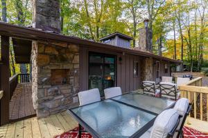a house with a glass table and chairs on a deck at Blue Ridge Retreat at Linville Land Harbor in Newland