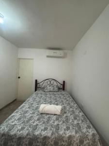 a bedroom with a bed with a pillow on it at loft in Hermosillo