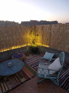 a patio with a table and chairs and lights at Dar Kawtar in Marrakesh