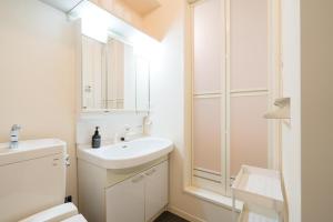 a white bathroom with a sink and a mirror at ハイツNagomi in Otsu +49 photos