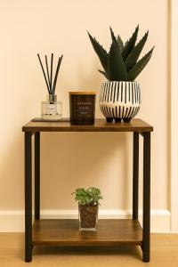 une table en bois avec deux plantes dessus dans l'établissement Erskine Apartment, à Angus 2 autres photos