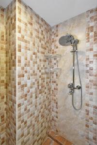 a bathroom with a shower with brown tiles at Ararat View Apartments in Yerevan