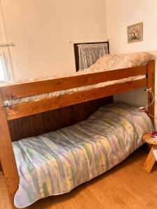 two bunk beds in a room with a bed at Chalet authentique au cœur du Mont d'Or in Métabief