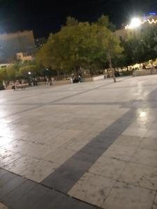 a square at night with a shadow on the ground at وسط البلد عمان in Amman
