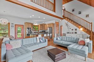 a living room with two blue couches and a kitchen at Peaceful View in Linville Falls