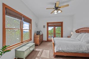 a bedroom with a bed and a ceiling fan at Peaceful View in Linville Falls
