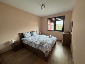 a bedroom with a bed and a window at Breathtaking sea view apartment in Varna City