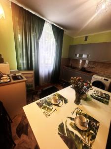 a kitchen with a table with hats on top of it at Wypoczynek Między Świerkami in Ustroń