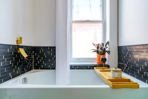 a bath tub in a bathroom with a window at Prime Location Top Rated Clean Parking Free! in Columbus