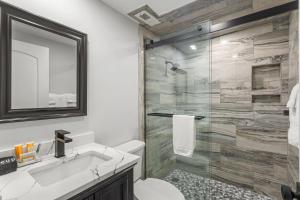 a bathroom with a shower and a toilet and a sink at 2371 Shipwatch Villa by Akers Ellis Rentals in Kiawah Island +41 photos
