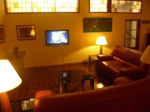 a living room with two couches and a tv at Hotel Pradas in Jaca