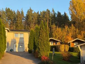a house with a driveway and a garage at Timrad Stuga med dubbelsäng med i stora huset dusch toalett och kök in Hedemora +19 photos