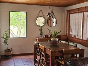 a dining room with a table and a mirror at Casa Uri in San Fernando