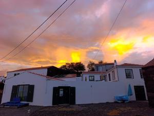 a house with a sunset in the background at Casa do Guardião in Madalena