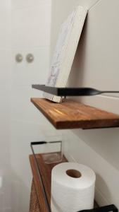 a roll of toilet paper on a wooden shelf at Jabego2 in Sarria