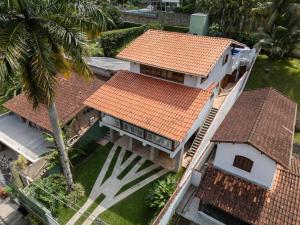 an overhead view of a house with an orange roof at Casa Varanda Guaecá Pet Friendly, Heated Pool in São Sebastião