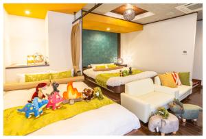 two beds in a room with stuffed animals on the floor at BaliAn Resort Chiba-Chuo in Chiba +84 photos
