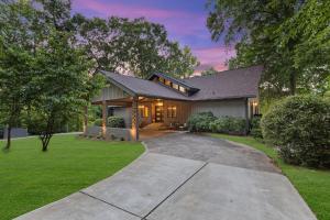 a home with a driveway leading to a house at Niblick on Norman w/Heated Pool & Optional Boat Rental in Cornelius