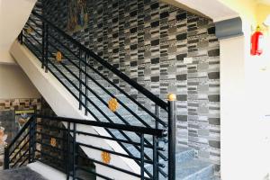 a staircase in a house with a brick wall at Collection O V K Lodge in Mandikal