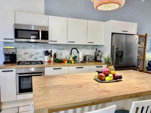 a kitchen with a table with a bowl of fruit on it at Fantastic Private Tropical Villa in Palm Beach with Breakfast in Palm-Eagle Beach