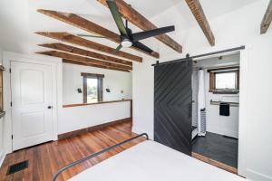 a room with a barn door and a ceiling fan at Uprising A pet friendly couples retreat in Lynchburg +60 photos