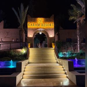 a set of stairs leading to a resort at night at RS Hôtel Karam Resort in Ouarzazate