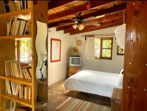 a bedroom with a bed and a book shelf at Cabañas Claudia in Valle de Guadalupe